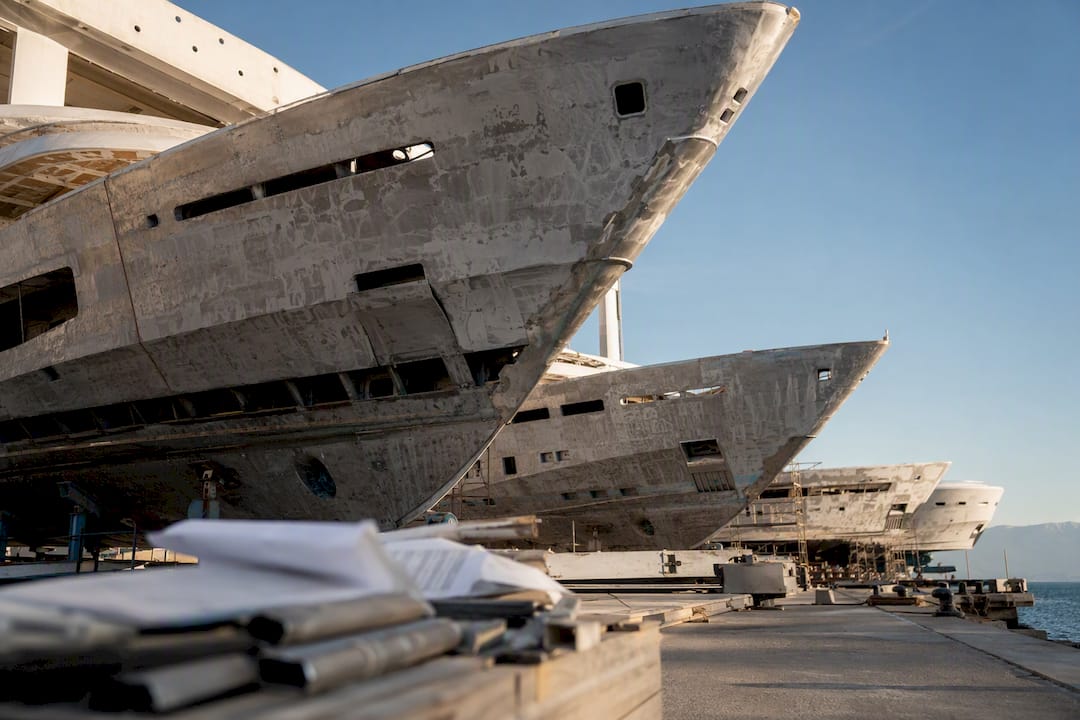 Luxury yacht hulls at shipyard dock